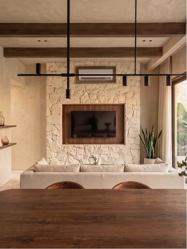 Casa Sorene Canggu living area — sunken sofa, Netflix TV, pool and garden view through floor-to-ceiling glass