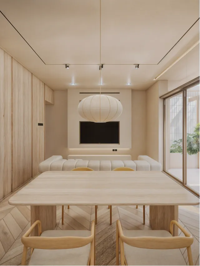 Casa Sorene Berawa living area — sunken sofa, Netflix TV, pool and garden view through floor-to-ceiling glass